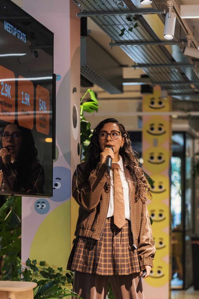 Service Young woman presenting statistics during a meetup at a modern office space.